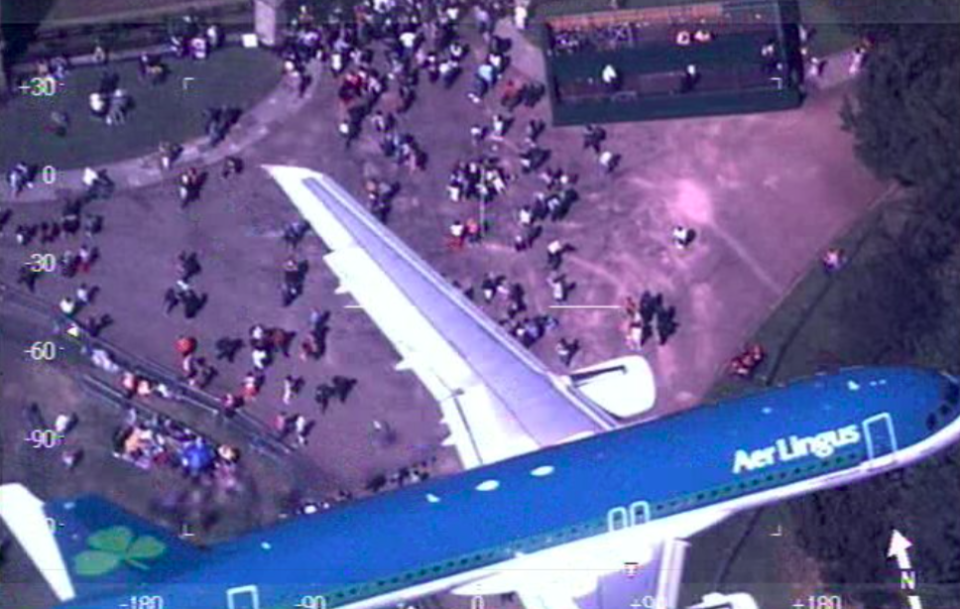 <em>A police helicopter caught an Aer Lingus commercial jet flying over the crowds at the Royal Wedding (Twitter/@NPASBenson)</em>