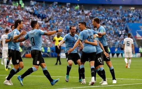 Uruguay's players celebrate the second goal of their team during the group A match between Uruguay and Russia at the 2018 soccer World Cup at the Samara Arena in Samara, Russia, Monday, June 25, 2018 - Credit: AP