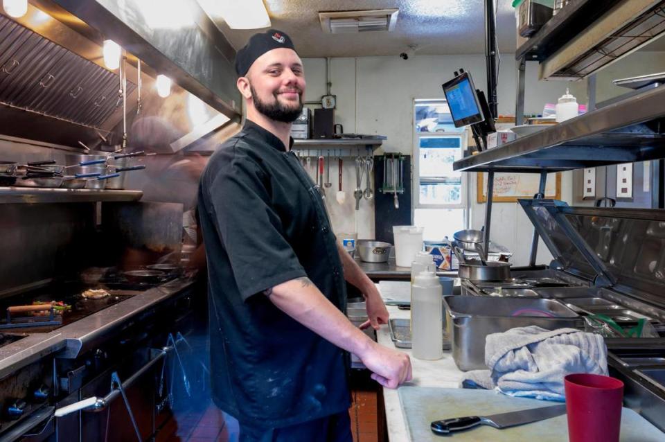 Justin Nesper poses for a photo as students in the Sierra-Pacific Teen Challenge drug-alcohol recovery program cook in the kitchen around him earlier this month at The Rustic Table Restaurant in Emigrant Gap. Nesper finished the program and stayed on to become a chef at the restaurant.