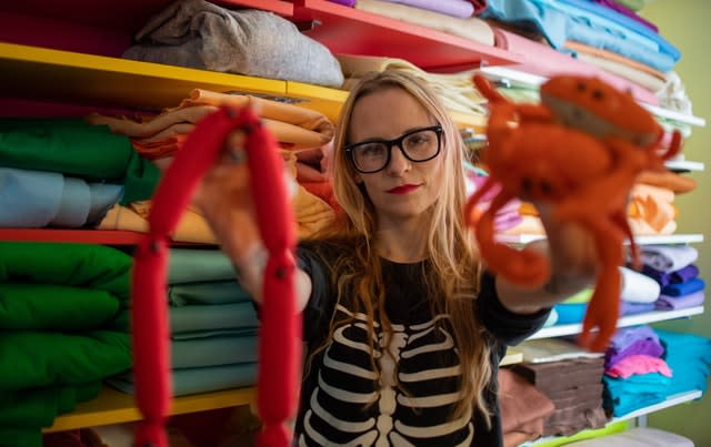 Lucy Sparrow in her workshop with some of her felt art pieces (Joe Giddens/PA)