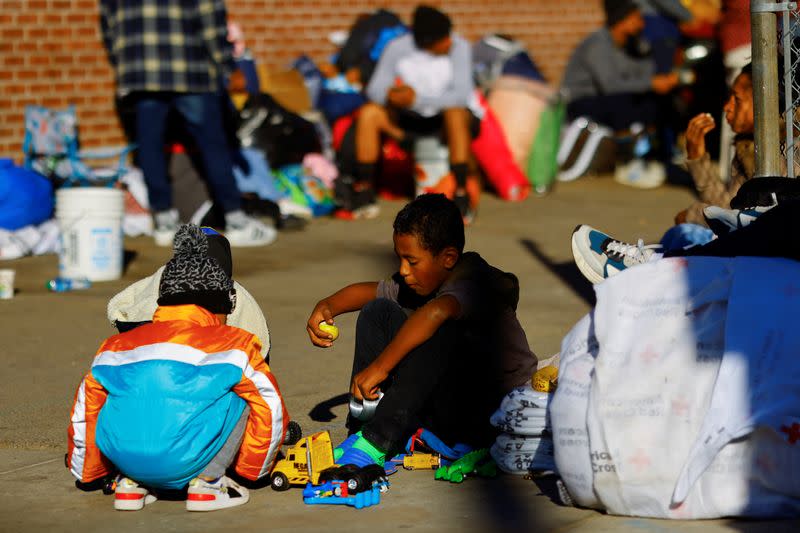 Migrant children play in the street on the day that U.S. President Biden and first lady Jill Biden visit El Paso