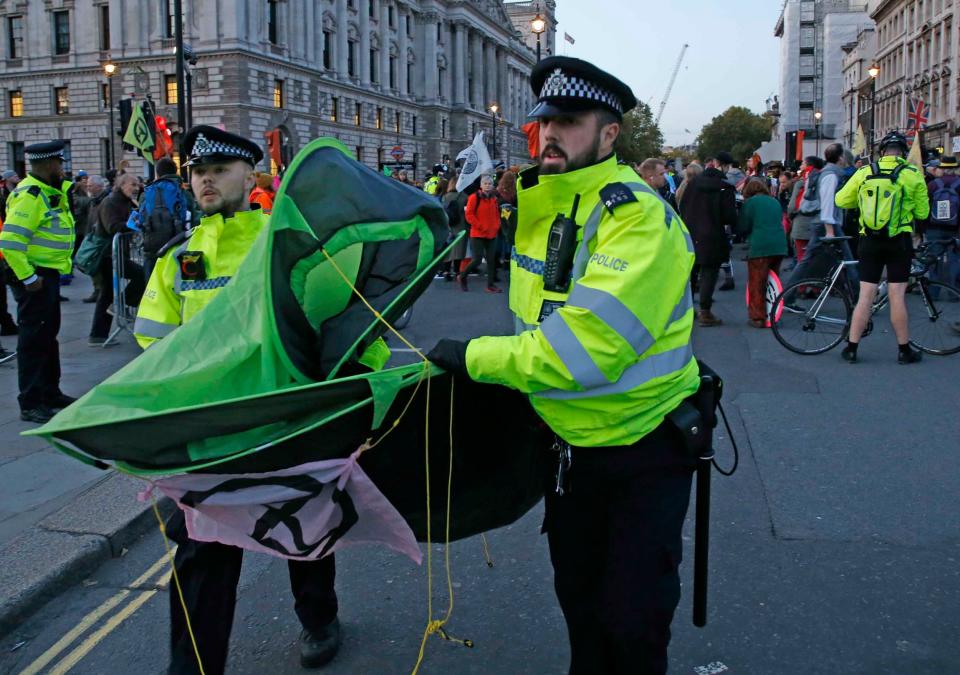 Police carry away a tent from an XR protest in Trafalgar Square (Nigel Howard)