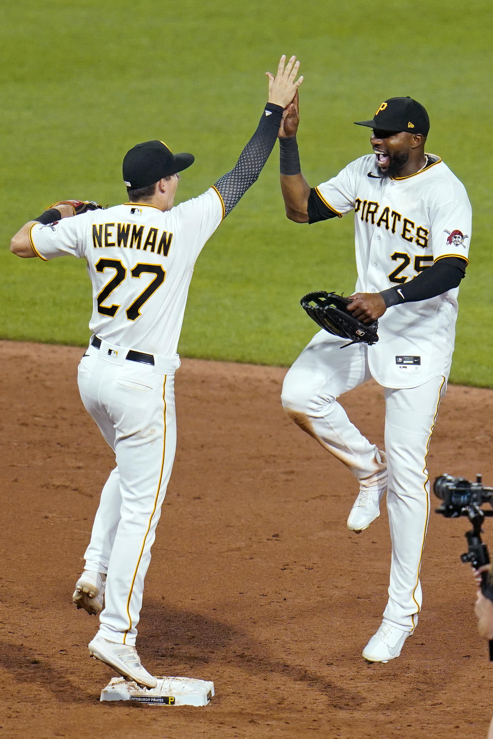 Pittsburgh Pirates' Gregory Polanco (25) and Kevin Newman celebrate after a win over the Cleveland Indians in a baseball game in Pittsburgh, Friday, June 18, 2021. (AP Photo/Gene J. Puskar)