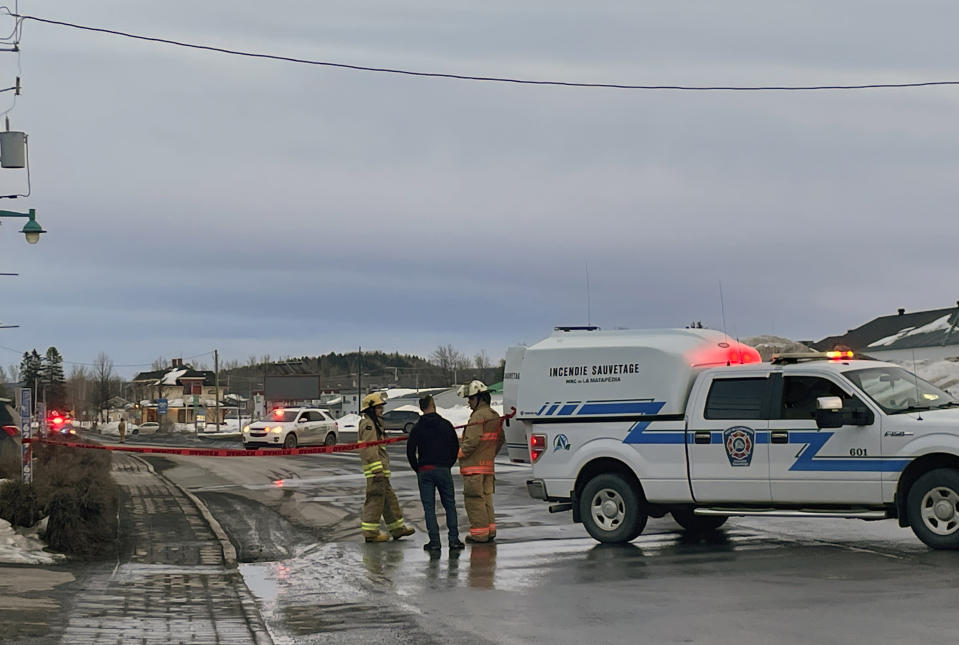 In this image provided by CTV News, first responders work the scene where two men died after a pickup truck plowed into pedestrians who were walking beside a road in Amqui, Quebec, Monday, March 13, 2023. (CTV News via AP)
