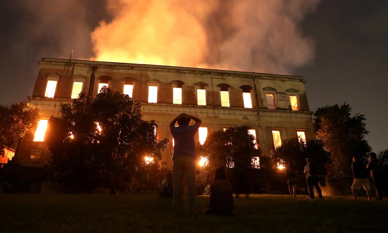 <span>People watch as a fire burns at the National Museum of Brazil in Rio de Janeiro on 2 September 2018.</span><span>Photograph: Ricardo Moraes/Reuters</span>