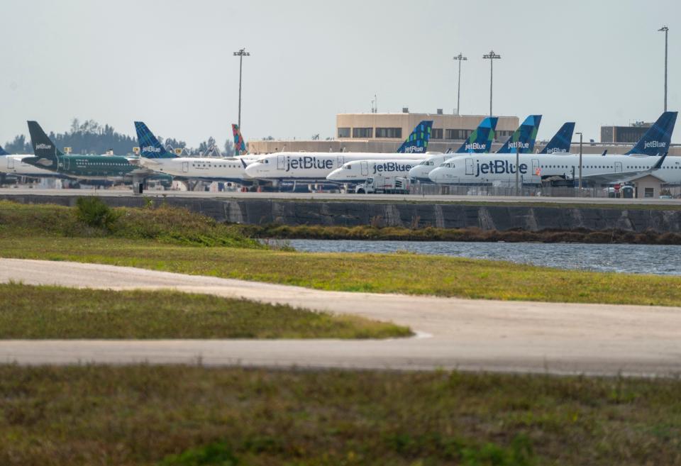 Jet Blue aircraft are parked at Palm Beach International Airport in West Palm Beach, Florida on April 9, 2020 as few flights are taking off since the coronavirus pandemic.