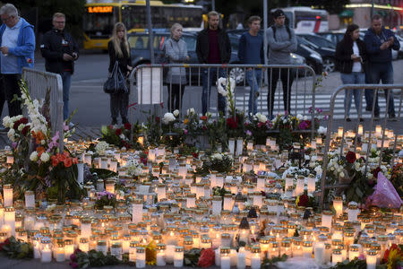 Memorial candles and flowers for the victims of Friday's stabbings are placed on the Market Square in Turku, Finland August 19, 2017. Lehtikuva/Vesa Moilanen/via REUTERS