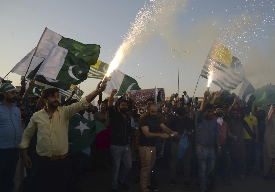 People celebrate the shooting down of Indian planes by Pakistani forces, with fireworks, in Karachi, Pakistan, Wednesday, Feb. 27, 2019. Pakistan's military said Wednesday it shot down two Indian warplanes in the disputed region of Kashmir and captured a pilot, raising tensions between the nuclear-armed rivals. (AP Photo/Muhammad Rizwan)