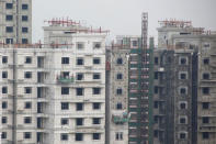 FILE PHOTO: Men work at a construction site of residential apartment blocks in Beijing, China, September 27, 2018. REUTERS/Thomas Peter/File Photo