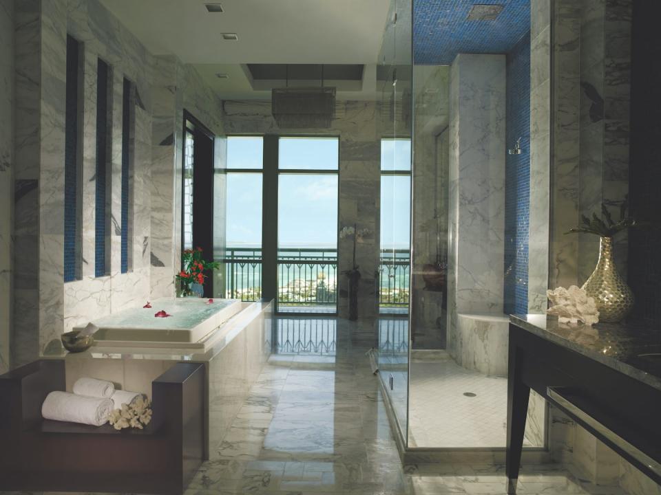 The marble-clad bathroom in the primary bedroom in the Penthouse Suite.