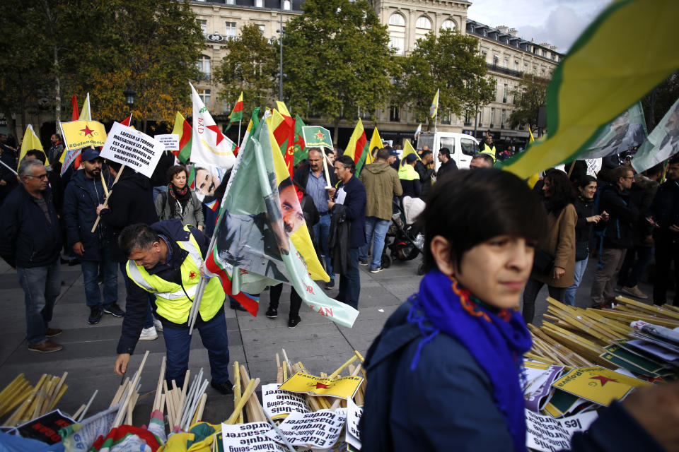 Protesters take part of a demonstration against Turkey's offensive in northern Syria, on Republique plaza in eastern Paris, Saturday, Oct. 19, 2019. Demonstrators warned that the offensive could allow Islamic State extremists to resurge. Kurdish forces being targeted by Turkey this week were crucial to the international campaign against IS extremists, who orchestrated several deadly attacks against France. (AP Photo/Thibault Camus)