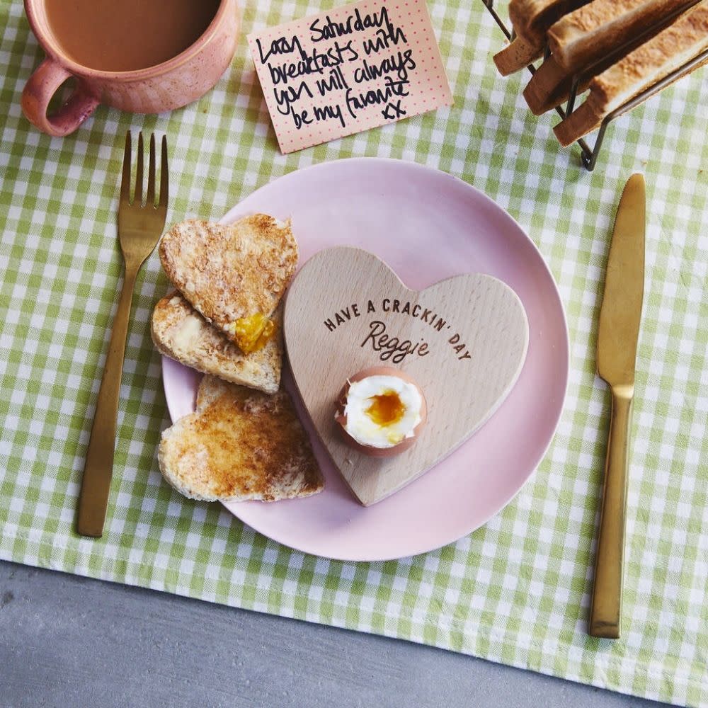  Oakdene Designs Personalised 'Have A Cracking Day' Dippy Egg Board on pink plate with boiled egg, toast, gold cutlery and mug of tea. 