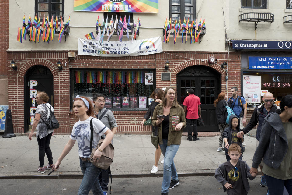 In this Oct. 11, 2017 file photo, People pass the Stonewall Inn, in New York City's West Village. The bar was the site of the Stonewall uprising that started on June 28, 1969 and galvanized the Gay Rights Movement. June 2019 Pride Month marks the 50th Anniversary of the Stonewall uprising, with events that commemorate that moment and its impact through the last five decades. (AP Photo/Mark Lennihan, File)