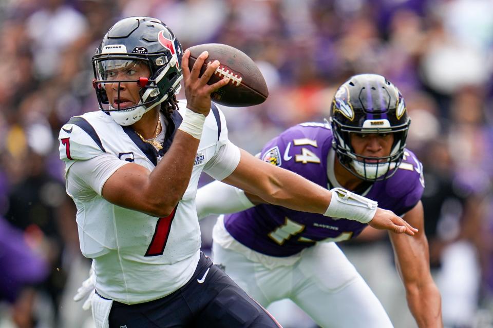 Houston Texans' C.J. Stroud gets past Baltimore Ravens' Kyle Hamilton during the first half of an NFL football game Sunday, Sept. 10, 2023, in Baltimore. (AP Photo/Julio Cortez)