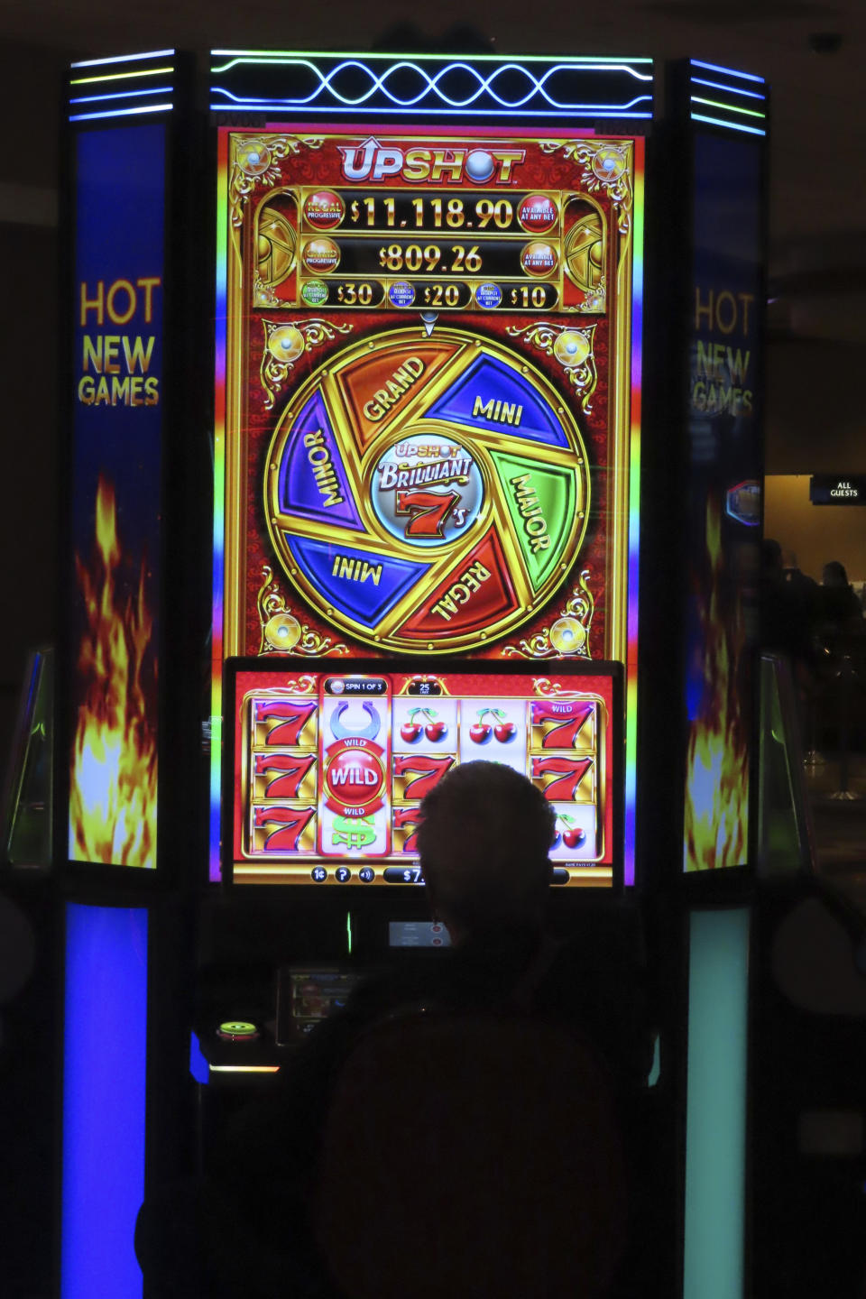 A gambler plays a slot machine at Harrah's casino in Atlantic City, N.J., on Sept. 29, 2023. On Nov. 21, 2023, New Jersey gambling regulators said Atlantic City's casinos and two internet-only entities earned $281.2 million in the third quarter of this year, a decline of 7.5% from the same period a year ago. (AP Photo/Wayne Parry)