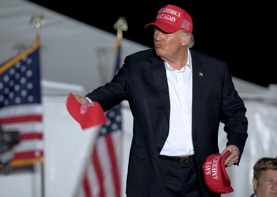 Former President Donald Trump throws hats to supporters at a rally, Saturday, Oct. 22, 2022, in Robstown, Texas. (AP Photo/Nick Wagner)