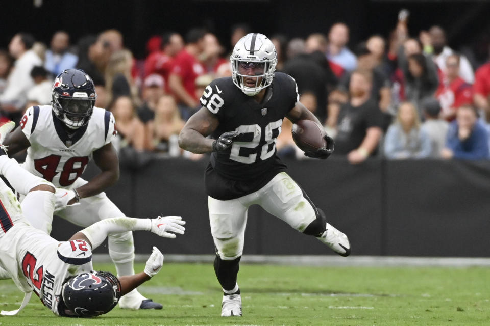 Las Vegas Raiders running back Josh Jacobs runs with the ball during the first half of an NFL football game against the Houston Texans, Sunday, Oct. 23, 2022, in Las Vegas. (AP Photo/David Becker)