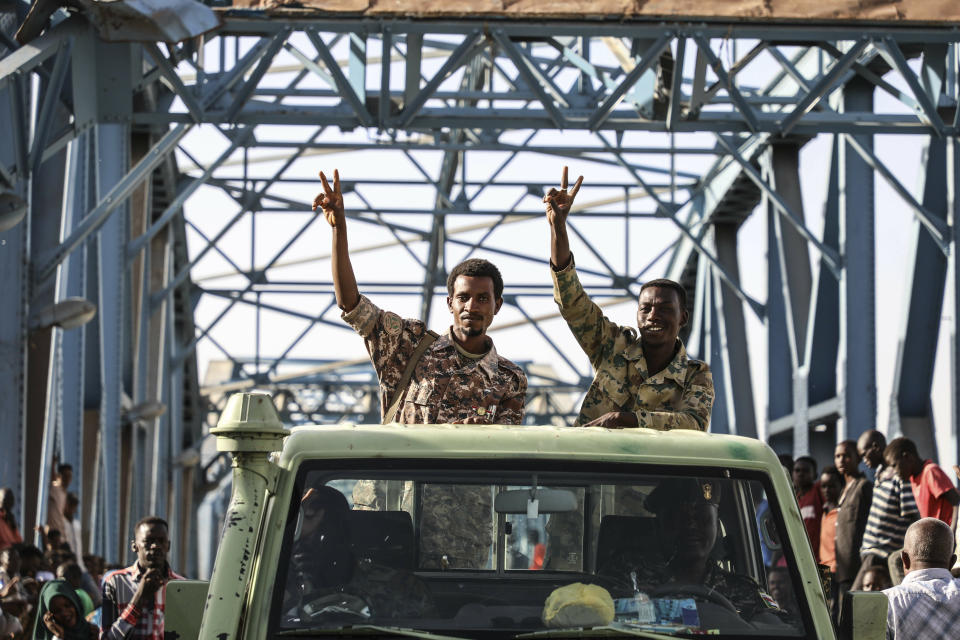 In this Tuesday, April 23, 2019, photo, soldiers gesture to Sudanese protesters in the capital Khartoum. Sudanese activists were holding nationwide protests on Tuesday to press the military to hand over power to a civilian authority after the overthrow of President Omar al-Bashir earlier this month.(AP Photo)