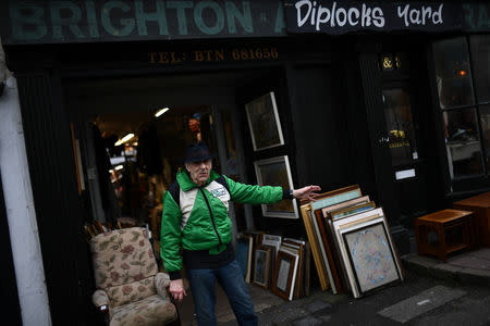 A man stands outside a shop front in Brighton, Britain March 6, 2019. REUTERS/Clodagh Kilcoyne