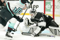 Seattle Kraken center Ryan Donato, left, tries to get a shot past Los Angeles Kings goaltender Cal Petersen during the third period of an NHL hockey game Monday, March 28, 2022, in Los Angeles. (AP Photo/Mark J. Terrill)