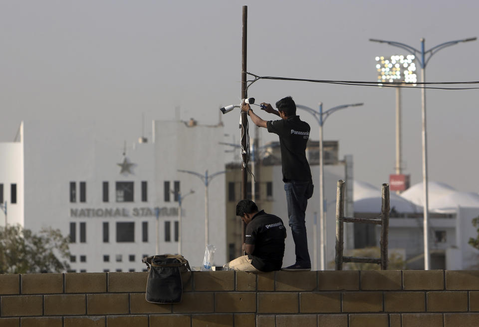 In this Feb. 9, 2019, photo, Pakistani technician fix security cameras at National Stadium ahead of upcoming Pakistan Super League in Karachi, Pakistan. The Pakistan Super League is not like any other domestic Twenty20 cricket league around the world. It can't compete financially with the lucrative Indian Premier League in terms of player payments, yet it's a dream for Pakistani cricketer to be part of it. For the Pakistan Cricket Board, the PSL is a pathway to ultimately bring foreign teams back to Pakistan and resume fully-fledged international cricket on home soil. (AP Photo/Fareed Khan)