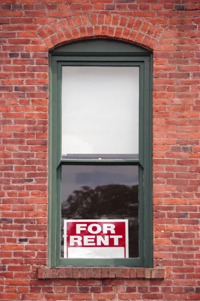 for rent sign in an apartment window