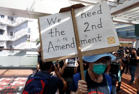 An anti-government protester holds a placard during a rally at the University of Hong Kong