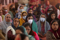 Sikh devotees, some of them wearing masks offer prayers during celebrations to mark the birth anniversary of the first Sikh Guru, Guru Nanak Dev, at a Gurudwara, or Sikh temple, in Jammu, India, Monday, Nov.30, 2020. India is second behind the U.S. in total coronavirus cases. Its recovery rate is nearing 94%. (AP Photo/Channi Anand)