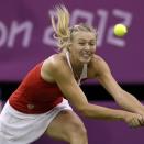 Maria Sharapova of Russia returns to Shahar Peer of Israel at the All England Lawn Tennis Club in Wimbledon, London at the 2012 Summer Olympics, Sunday, July 29, 2012. (AP Photo/Elise Amendola)