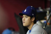 Los Angeles Dodgers' Shohei Ohtani, of Japan, watches the action from the dugout during the second inning of a baseball game against the Arizona Diamondbacks Wednesday, May 1, 2024, in Phoenix. (AP Photo/Ross D. Franklin)