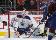 Edmonton Oilers goaltender Calvin Pickard, left, stops a shot by Colorado Avalanche right wing Valeri Nichushkin during the second period of an NHL hockey game Thursday, April 18, 2024, in Denver. (AP Photo/David Zalubowski)