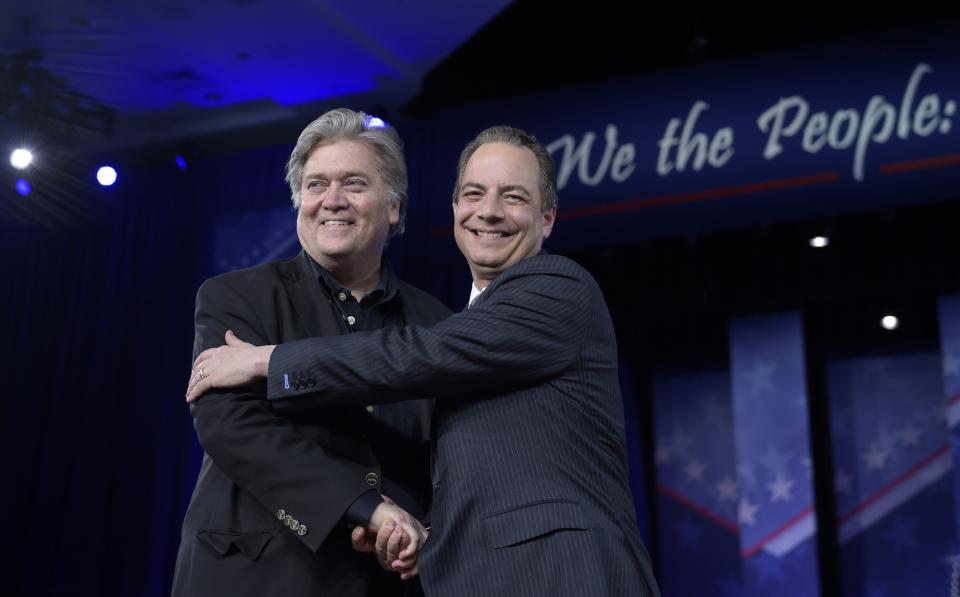 White House chief of staff Reince Priebus, right, hugs White House strategist Steve Bannon as they are introduced to speak at the Conservative Political Action Conference. (Photo: Susan Walsh/AP)