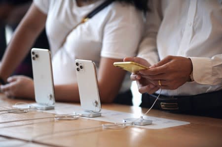 People look at Apple's new iPhone 11, iPhone 11 Pro, and iPhone 11 Pro Max models at the Apple Store in IFC, Central district, Hong Kong, China