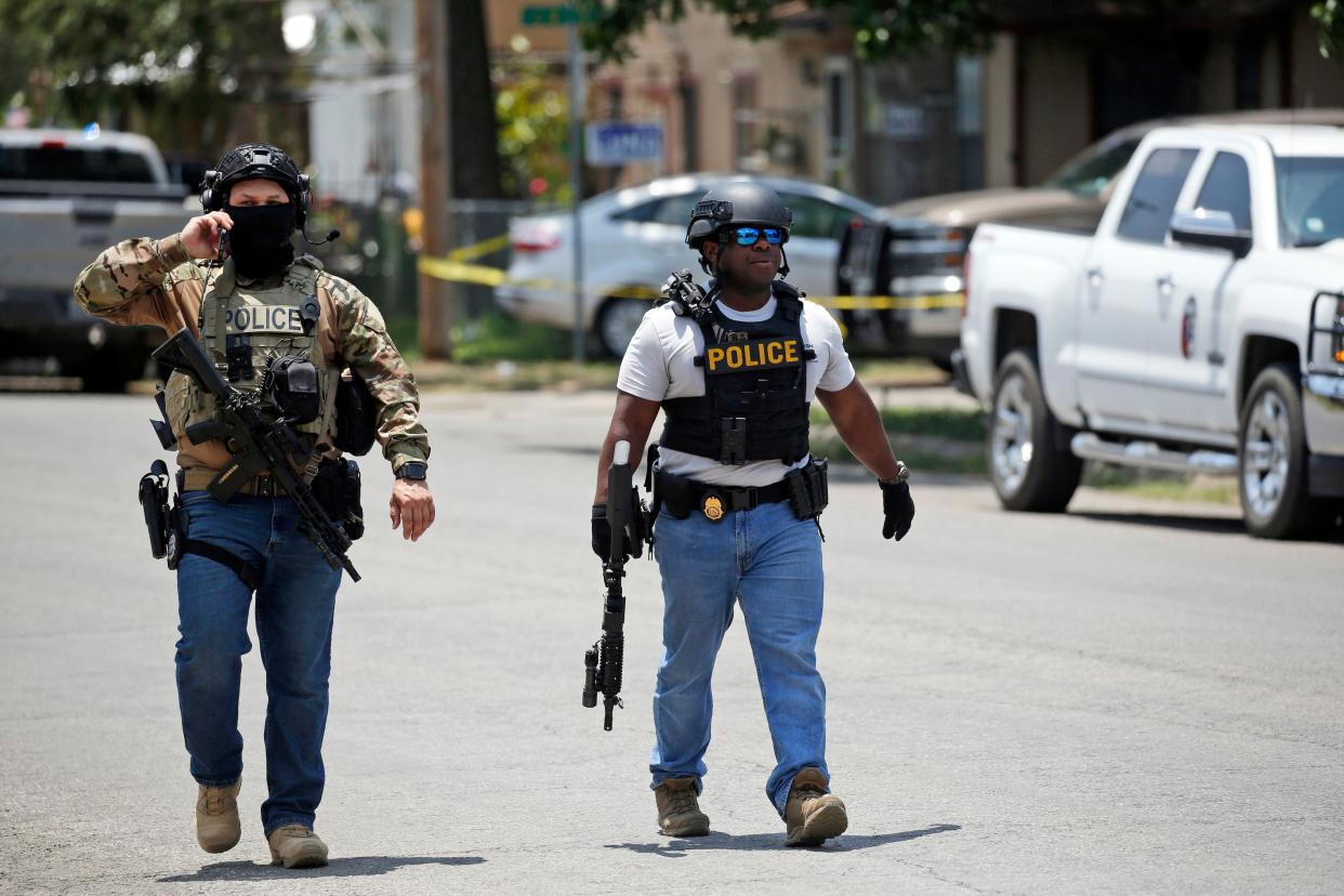 Police walk near Robb Elementary School following a shooting, Tuesday, May 24, 2022, in Uvalde, Texas. 