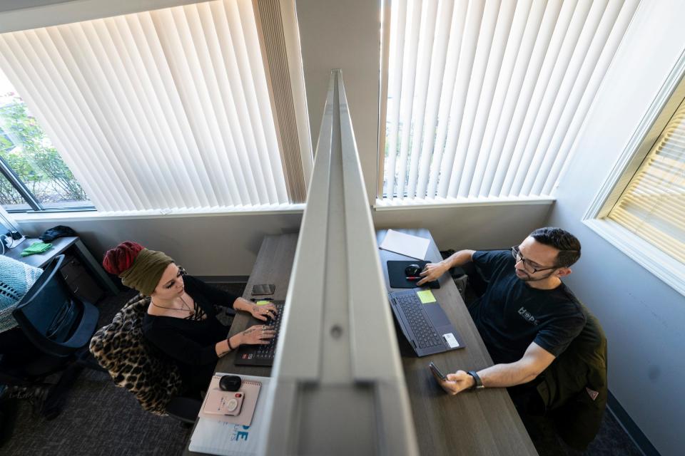 Hope not Handcuffs volunteers Emily Taube, 23, left and Anthony Elia, 28, of Warren, work the call center for those seeking help with substance use disorder at the Clinton Township offices on Nov. 22, 2022.