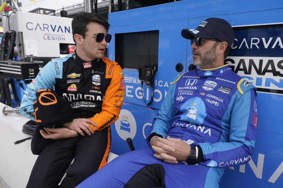 Pato O'Ward, of Mexico, talks with Jimmie Johnson before practice for the Indianapolis 500 auto race at Indianapolis Motor Speedway, Monday, May 23, 2022, in Indianapolis. (AP Photo/Darron Cummings)