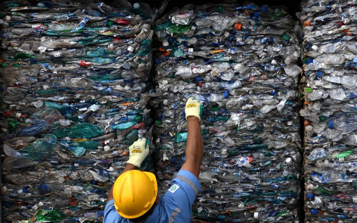 An officer shows a container full with plastic waste at Tanjung Priok port in Jakarta, Indonesia. - via REUTERS