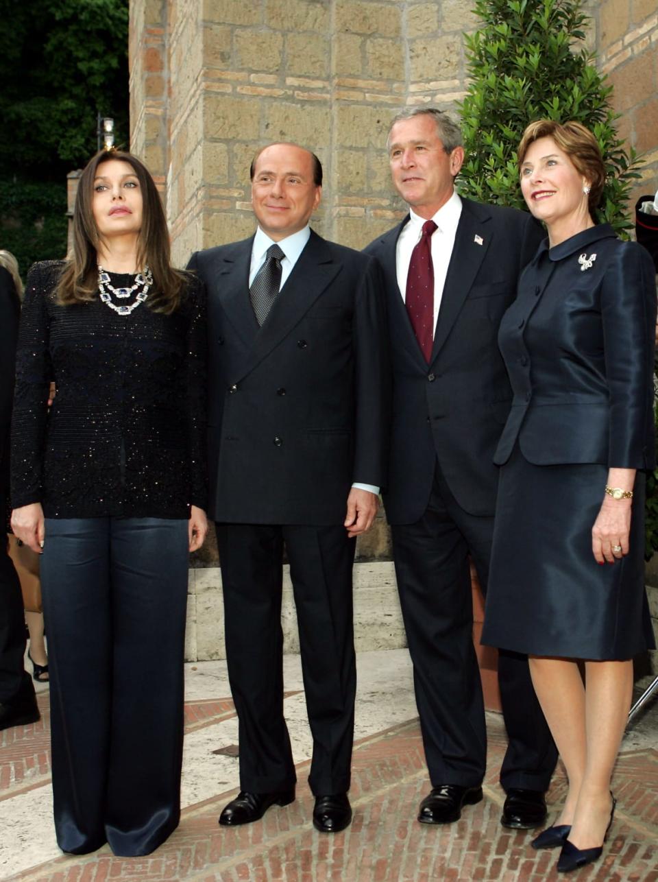 <div class="inline-image__caption"><p>Silvio Berlusconi and his then-wife Veronica Lario pose with President George W. Bush his wife, Laura, in Italy in 2004. Thousands of armed police lined the streets of the Italian capital as activists gathered to protest against the visiting president and the U.S.-led occupation of Iraq. </p></div> <div class="inline-image__credit">Reuters</div>