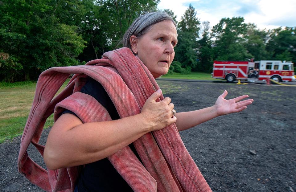 Lynn Kirkner, a firefighter with the Hartsville Fire Company, in Warminster, on Wednesday, July 27, 2022, demonstrates how to carry the attack line hose after a drill during the station's firefighters camp for teenagers.