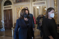 Vice President Kamala Harris arrives to break the tie on a procedural vote as the Senate works on the Democrats' $1.9 trillion COVID relief package, on Capitol Hill in Washington, Thursday, March 4, 2021. (AP Photo/J. Scott Applewhite)