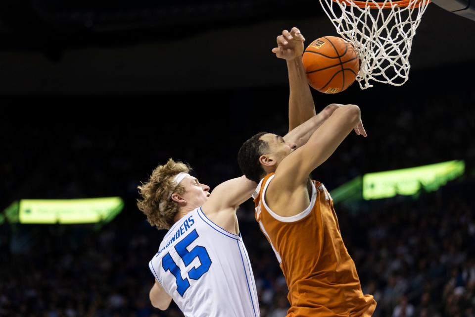 BYU guard, Richie Saunders (15) blocks Texas forward, Dylan Disu’s (1) shot during their game in Provo on Saturday, Jan. 27, 2024. BYU won 84-72. | Marielle Scott, Deseret News