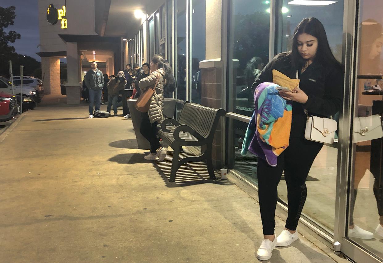 Yaisel Castillo, 19, waits at the front of the line Friday morning at the South Austin driver's license office. She arrived at 3:30 a.m., hours before the office opened at 8 a.m., to ensure she'd get a same-day appointment for a state ID she needs for her new job.