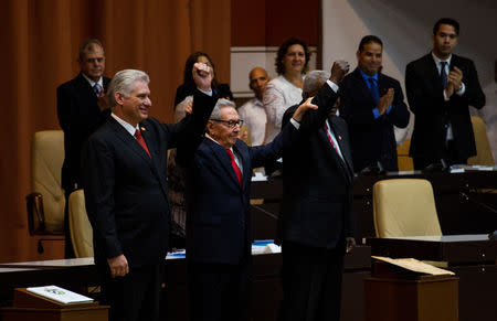 Cuban President Miguel Diaz-Canel (L), Cuban Communist Party leader Raul Castro (C) and National Assembly President Esteban Lazo react during the enactment of the new constitution, in Havana, Cuba April 10, 2019. Irene Perez/Courtesy Cubadebate/Handout via REUTERS