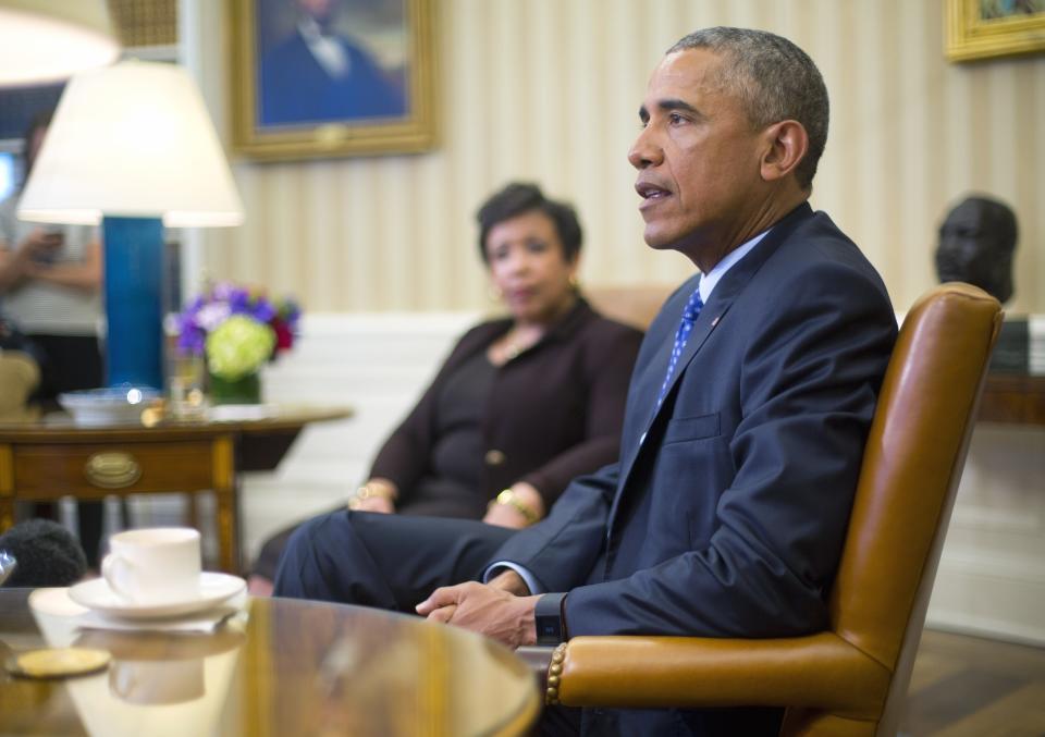 Former U.S. Attorney General Loretta Lynch listens as former President Barack Obama speaks in the Oval Office of the White House in Washington, Monday, Jan. 4, 2016.