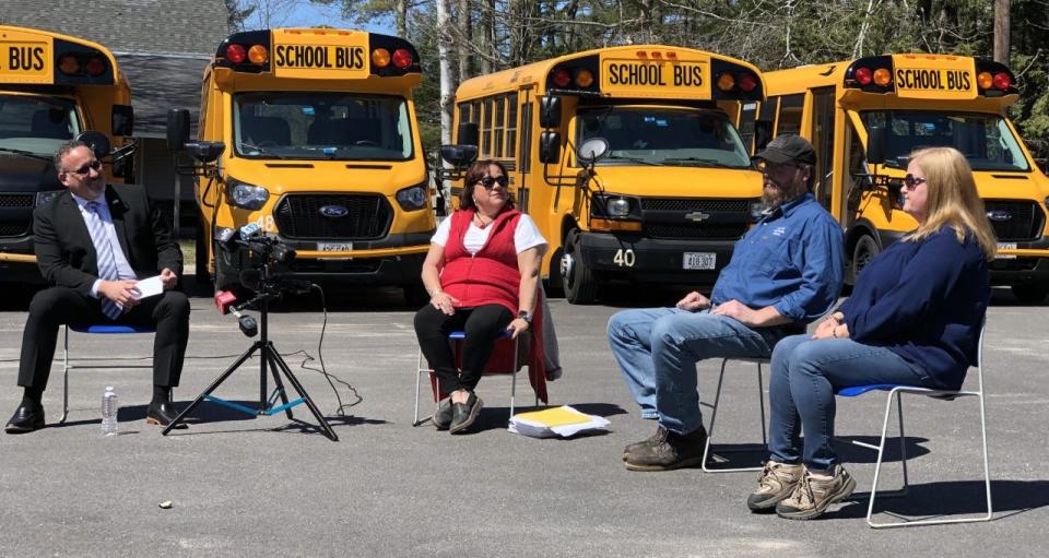 U.S. Education Secretary Dr. Miguel Cardona, left, discusses bus driving with RSU 21 transportation employees Cindy Messier, Frank West and Renda Turner in Kennebunk on Monday, April 11, 2022.