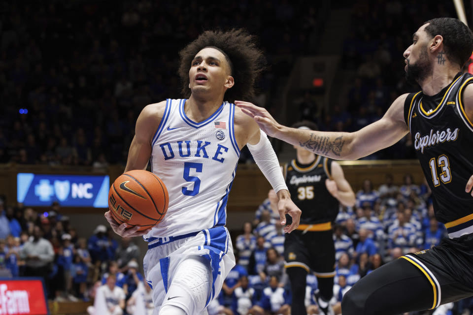 Duke's Tyrese Proctor (5) drives past La Salle's Daeshon Shepherd (13) during the second half of an NCAA college basketball game in Durham, N.C., Tuesday, Nov. 21, 2023. (AP Photo/Ben McKeown)