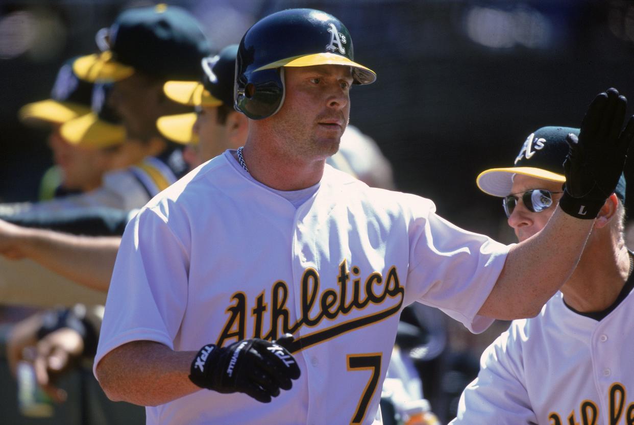 Jeremy Giambi #7 of the Oakland Athletics gives a high five during a game against the Chicago White Sox at the Network Associates Coliseum in Oakland, California. The Athletics defeated the White Sox 14-2. Mandatory Credit: Jed Jacobsohn  /Allsport
