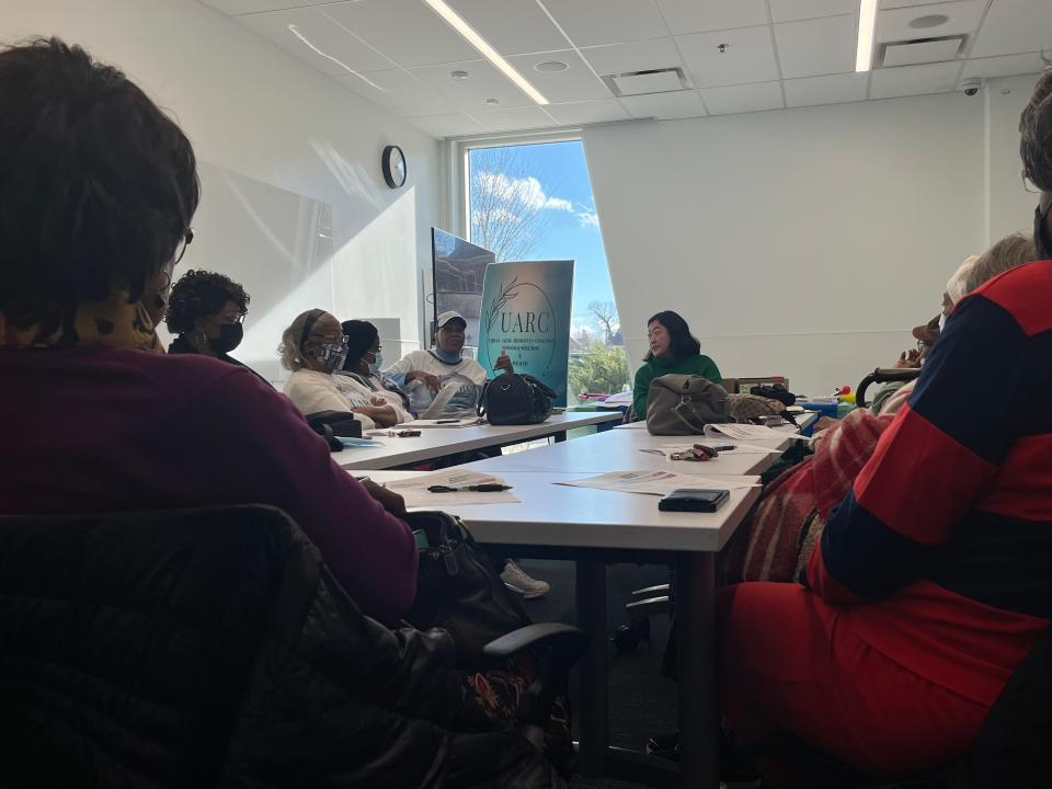 Attendees of an Urban Aging Residents Coalition meeting listen as Pamela Shields, center left, talks about mental health.