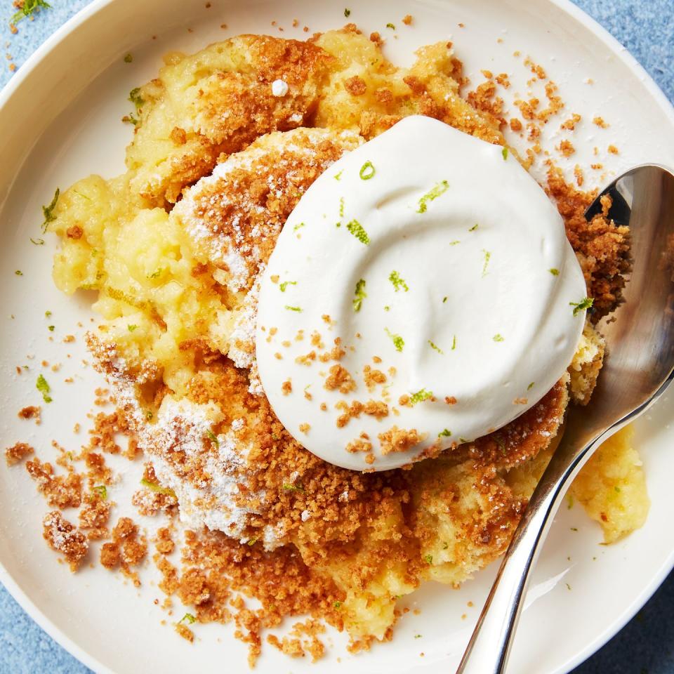 baked key lime pie pudding topped with whipped cream and lime zest