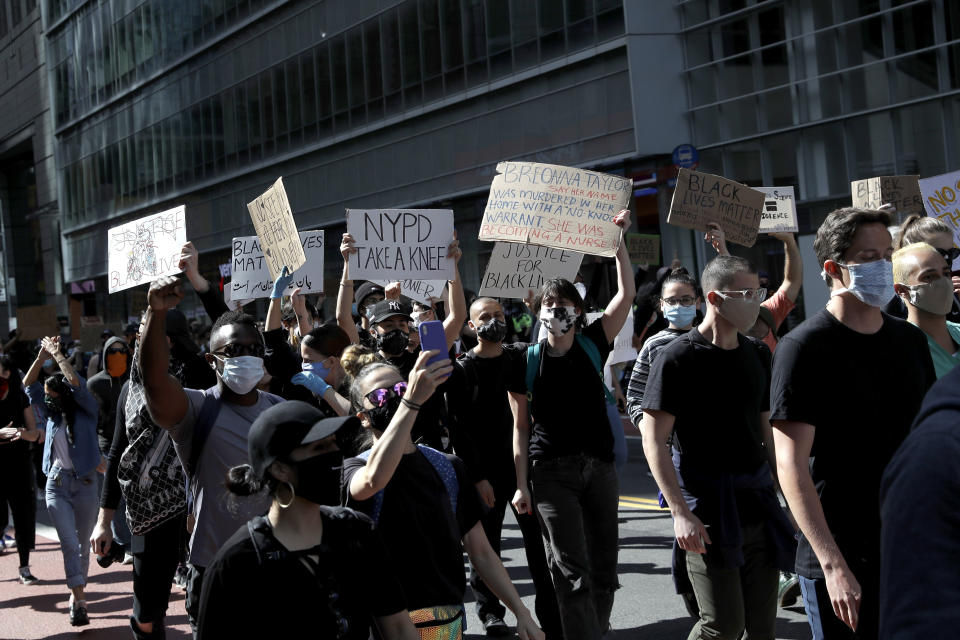 Protesters march through the streets of Manhattan in New York, Monday, June 1, 2020. New York City imposed an 11 p.m. curfew Monday as the nation's biggest city tried to head off another night of destruction erupting amid protests over George Floyd's death. (AP Photo/Seth Wenig)